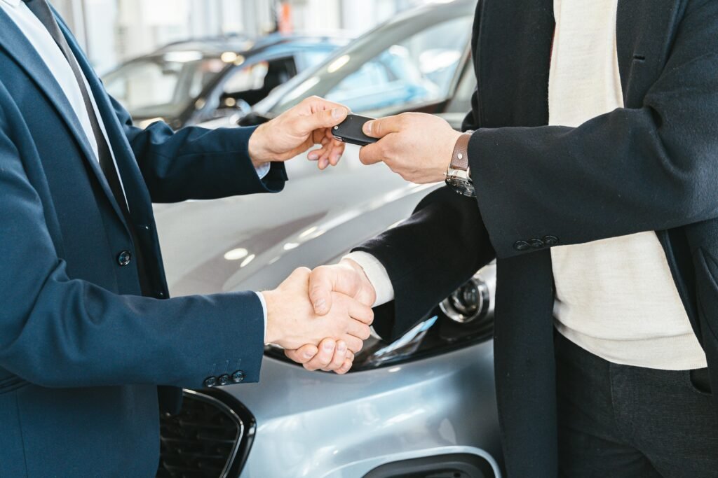 Car Salesman Shaking Hands With Buyer
